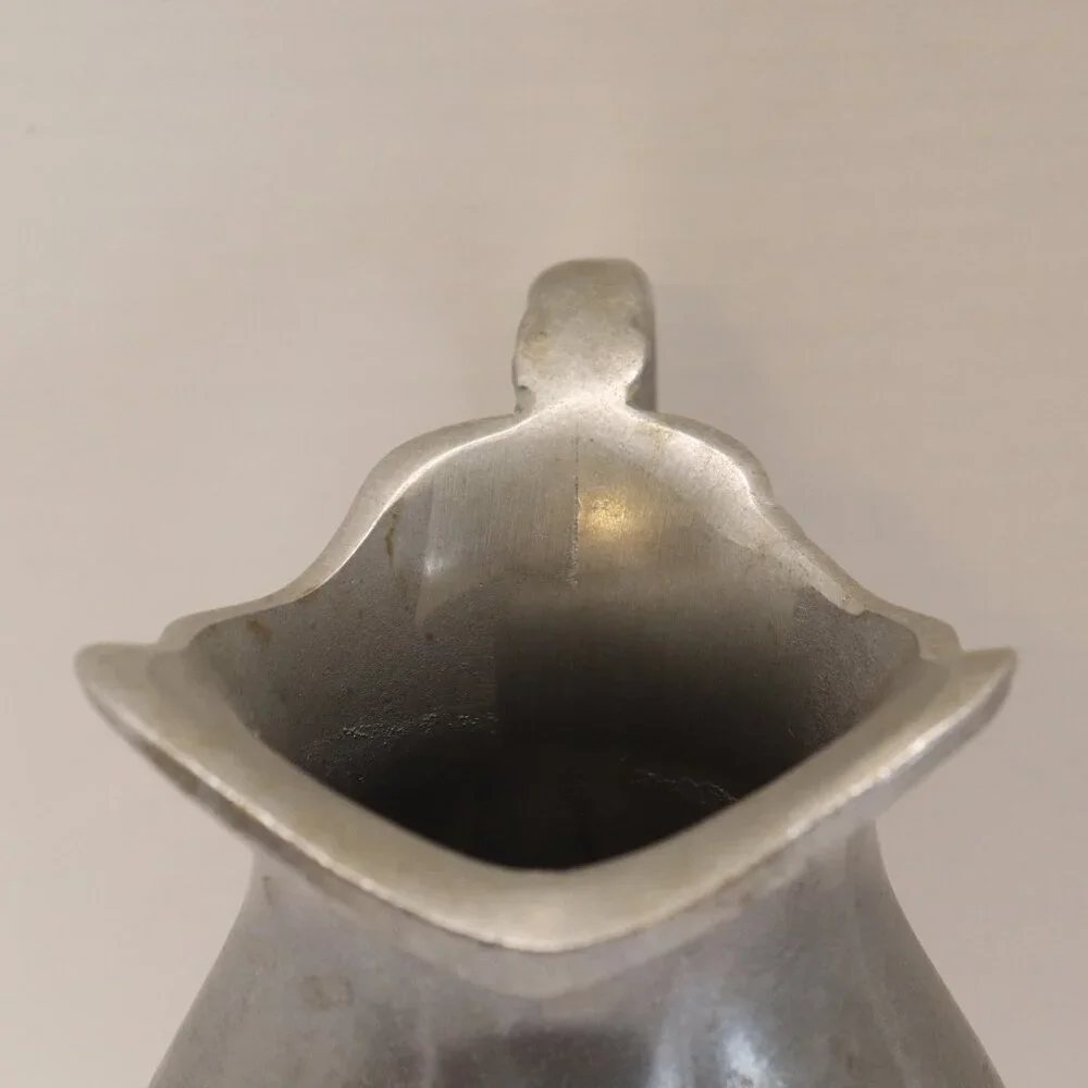 A Heavy Pewter Water Pitcher Pre Owner with some signs of wear